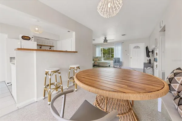 a view of a kitchen with furniture and a refrigerator