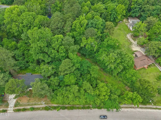 an aerial view of a house with yard