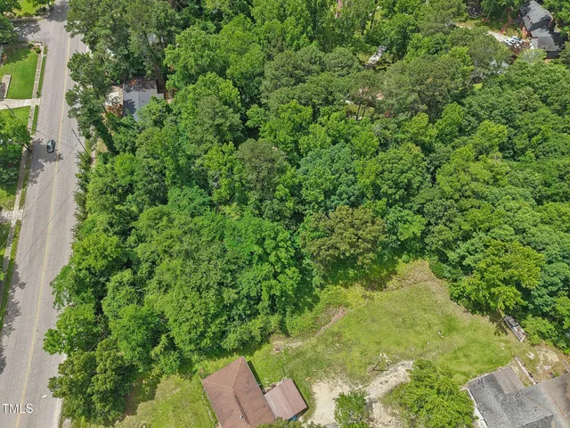 an aerial view of a house with yard