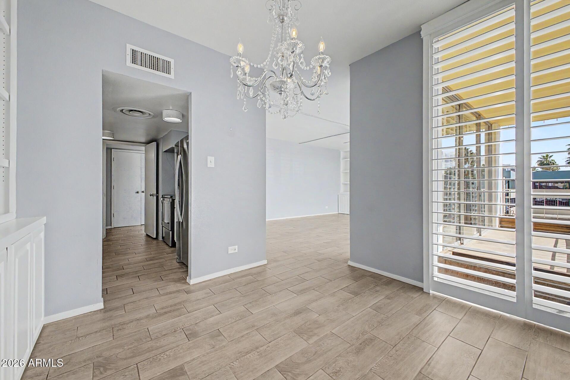 207 West Clarendon Avenue, Unit B2 Phoenix, AZ 85013 - Photo 5 of 30 a view of a hallway with windows and chandelier
