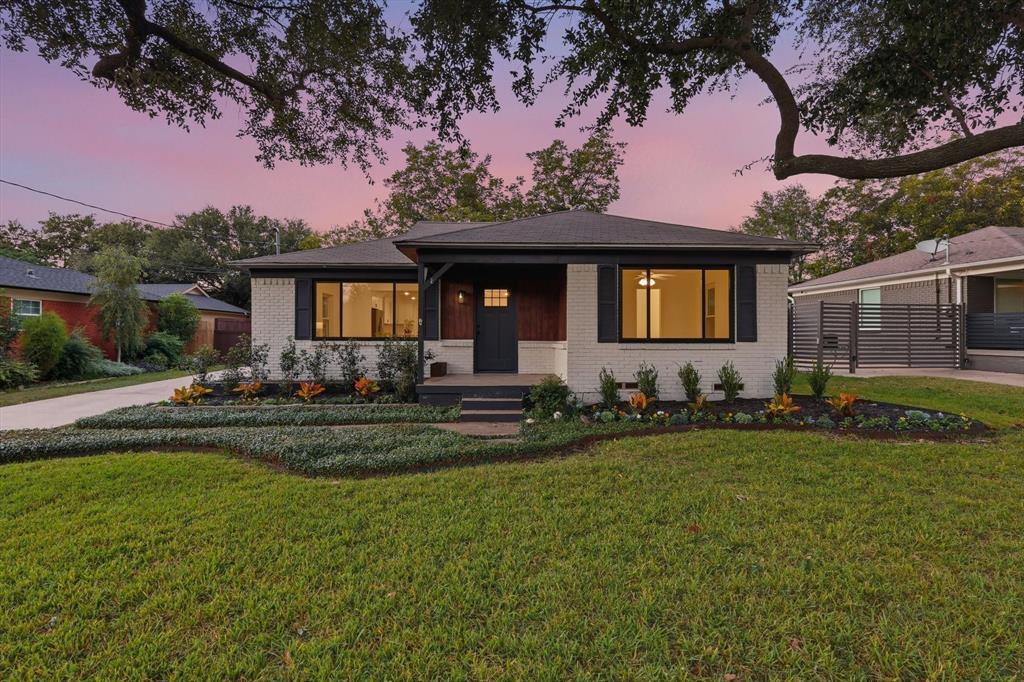 View of front of house featuring brick siding, a front yard, and a porch