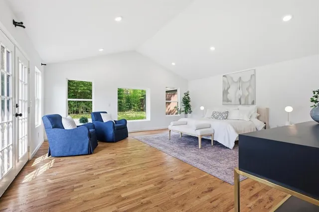 a living room with furniture windows and wooden floor