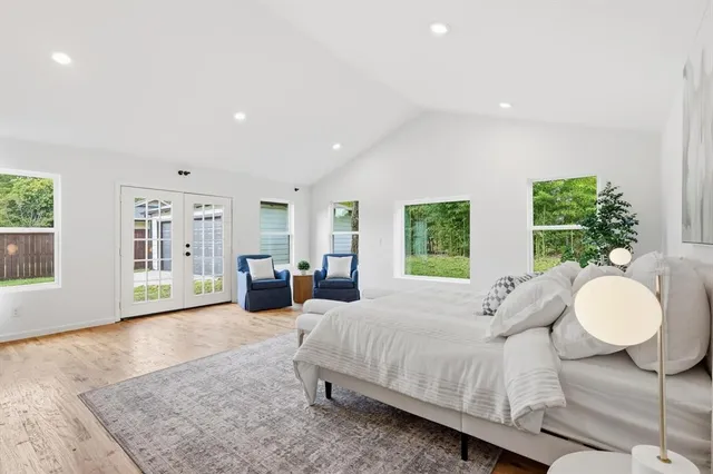 a spacious bedroom with a large bed and windows