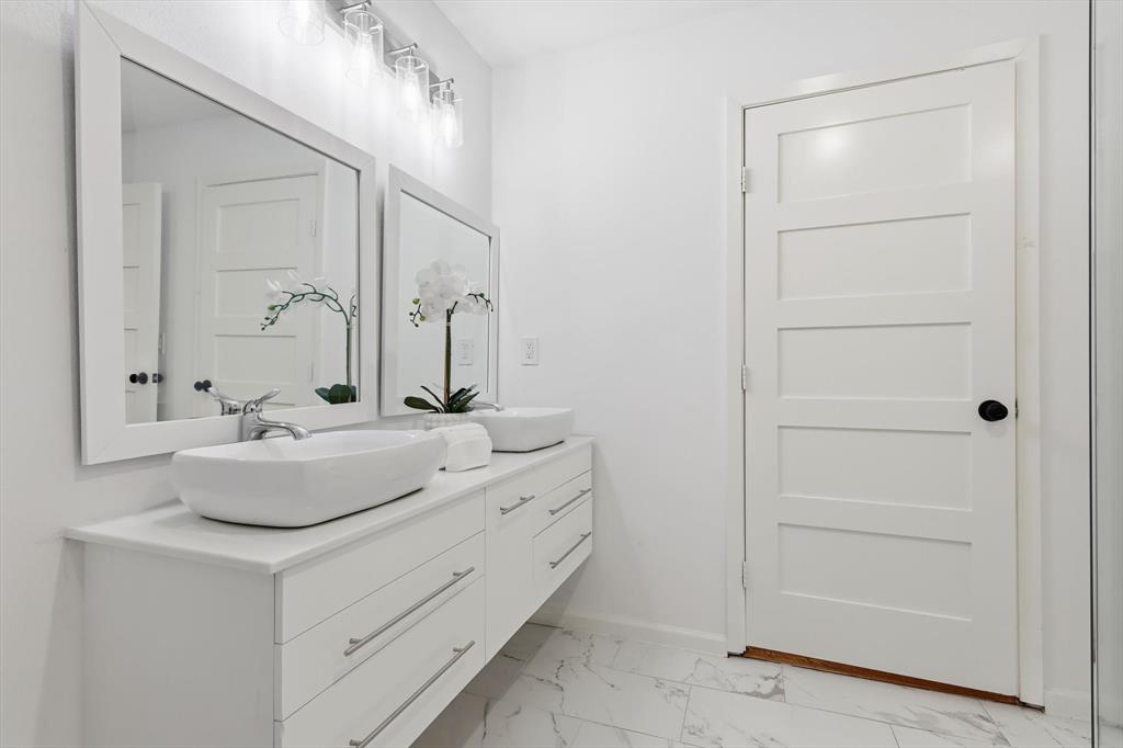 6811 Patrick Drive Dallas, TX 75214 - Photo 30 of 40 Bathroom with double vanity and light marble finish floors
