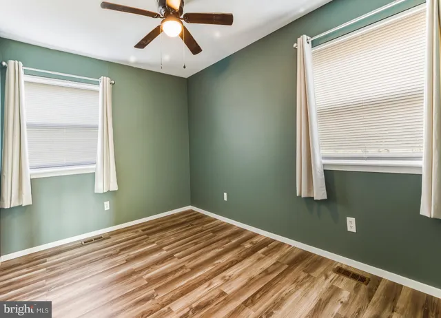 a view of room with window and ceiling fan