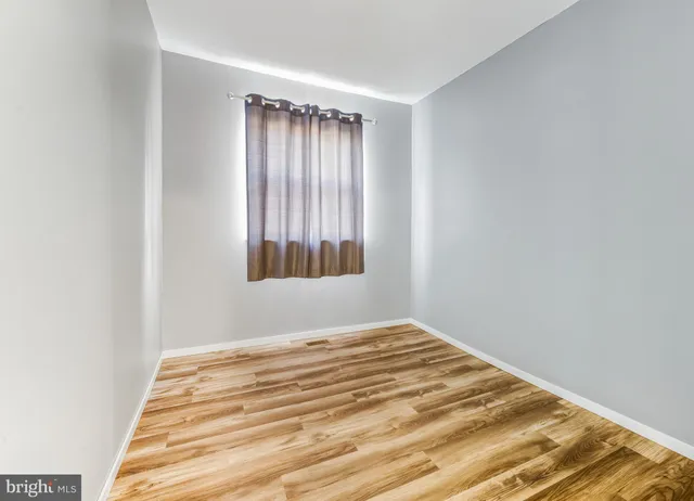 a view of wooden floor and windows in a room