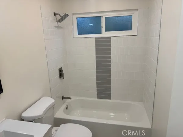 a bathroom with a toilet and a bathtub