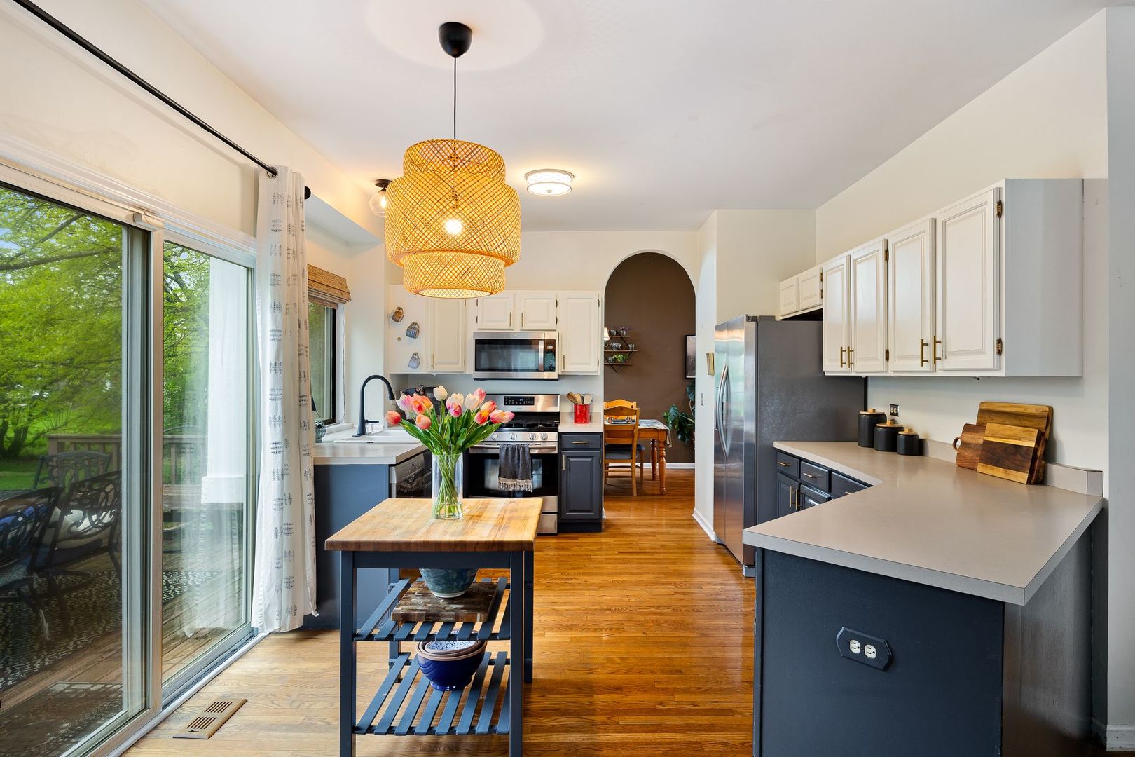 7781 Rippling Ridge Court Gurnee, IL 60031 - Photo 12 of 31 a kitchen with sink refrigerator dining table and chairs