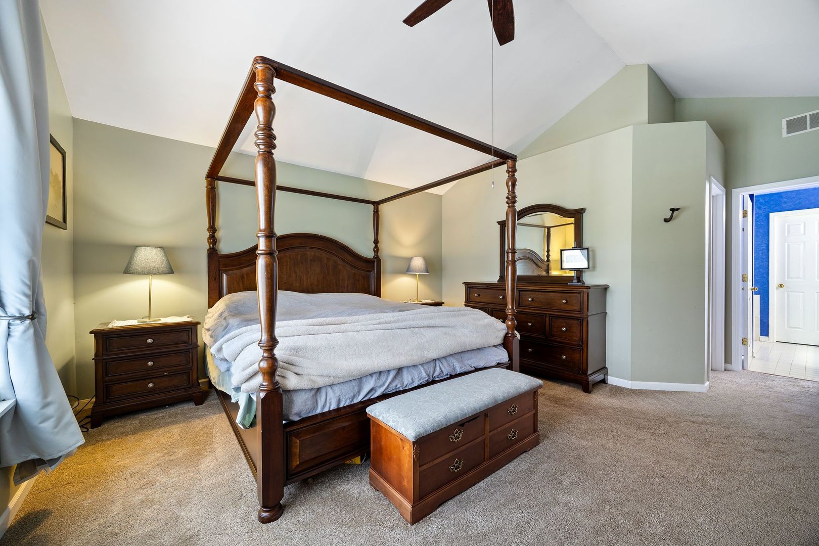 7781 Rippling Ridge Court Gurnee, IL 60031 - Photo 17 of 31 a bedroom with a bed a mirror on dresser and a flat tv screen on dresser
