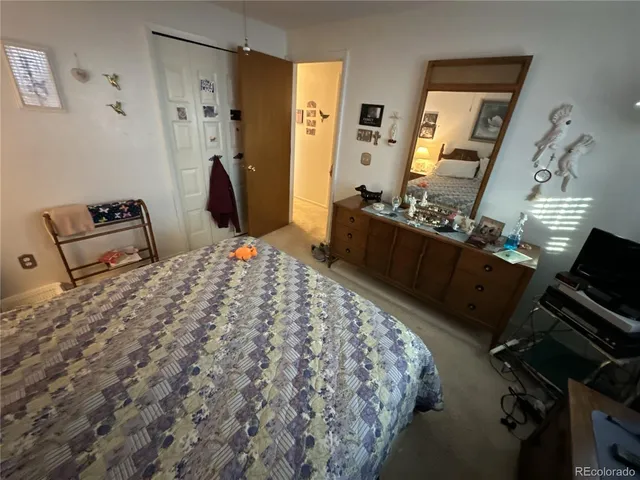 a bedroom with a bed dresser and a mirror