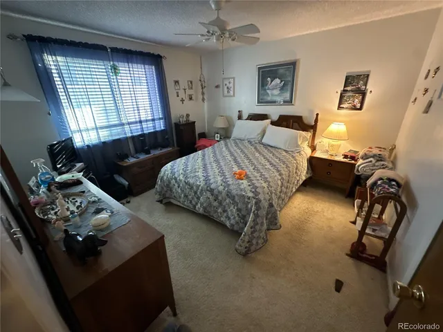 a bedroom with bed couch and window