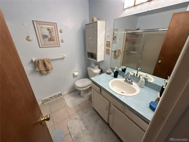 a bathroom with a sink and a mirror with toilet