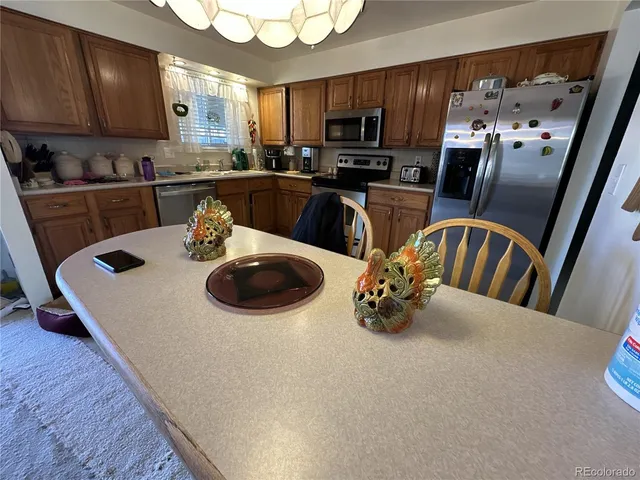 a kitchen with a sink a microwave and cabinets