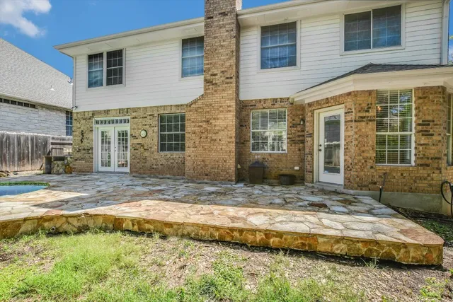 a front view of a house with a yard table and chairs