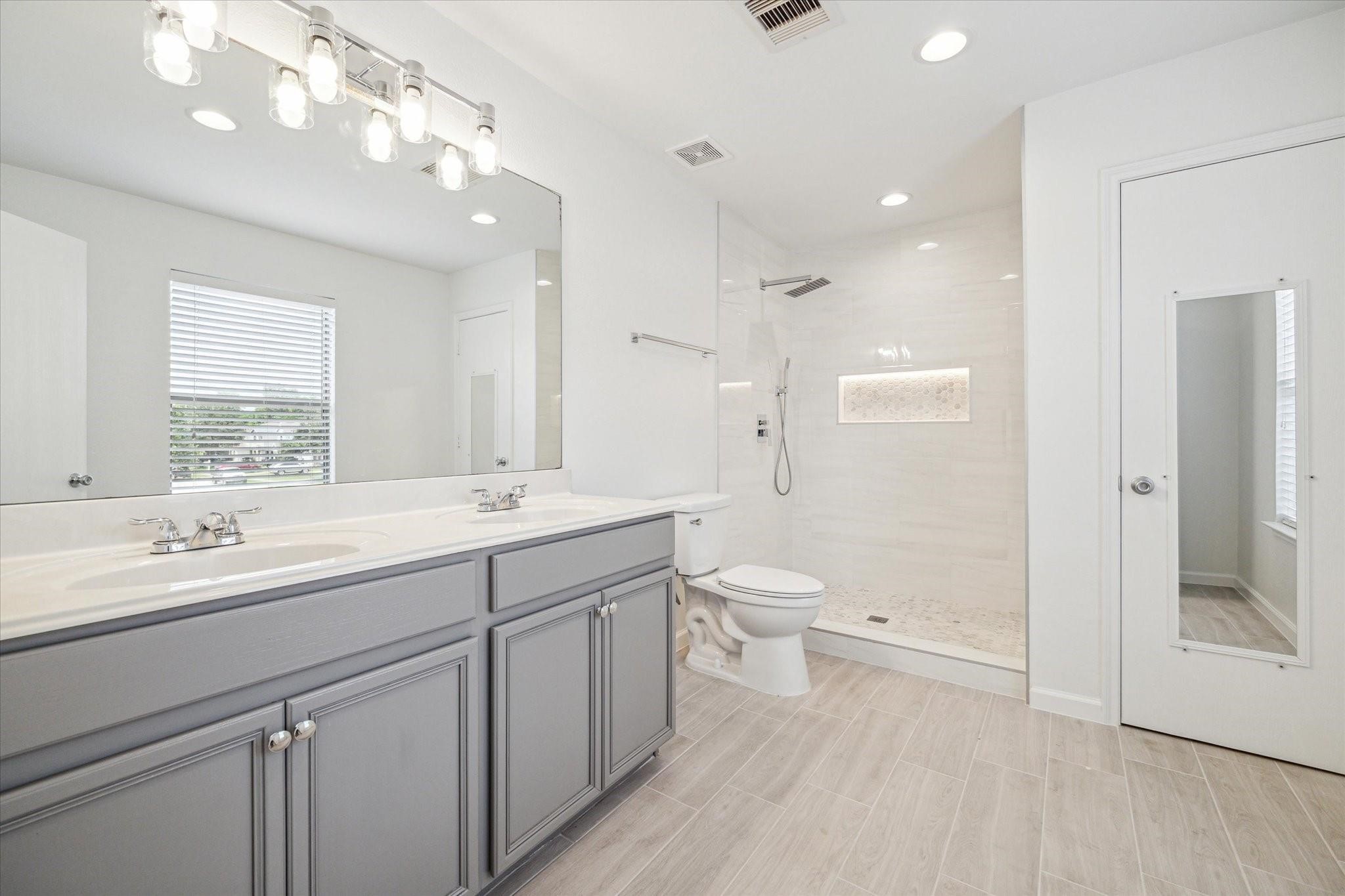 2950 Valiant Scene Court Houston, TX 77038 - Photo 11 of 21 a bathroom with a sink a toilet and shower