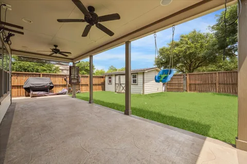 a view of a backyard with wooden fence
