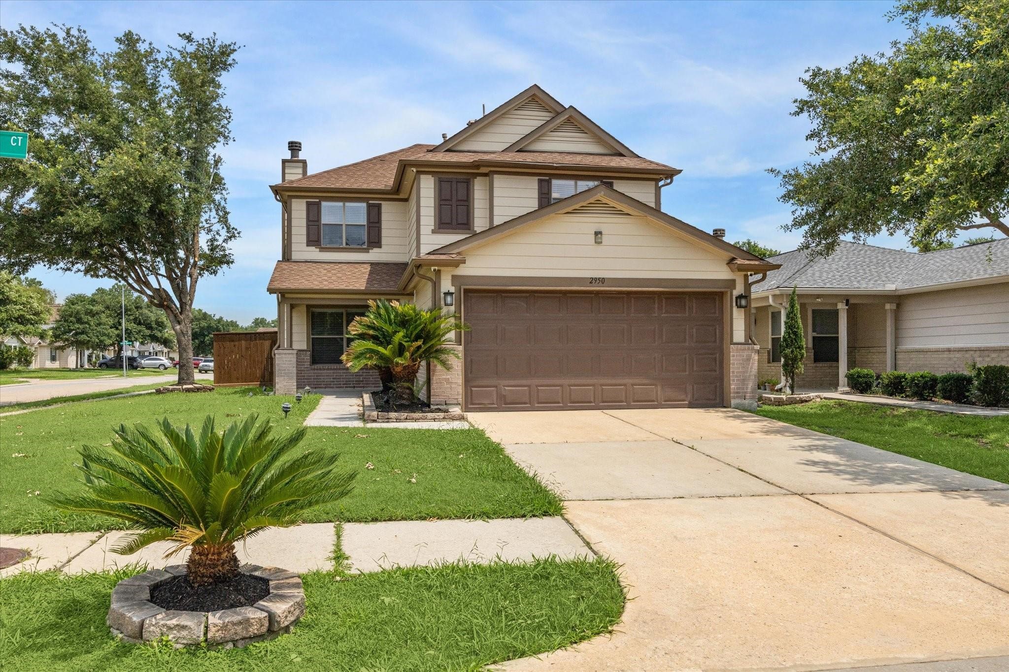 2950 Valiant Scene Court Houston, TX 77038 - Photo 2 of 21 a front view of a house with a yard and garage