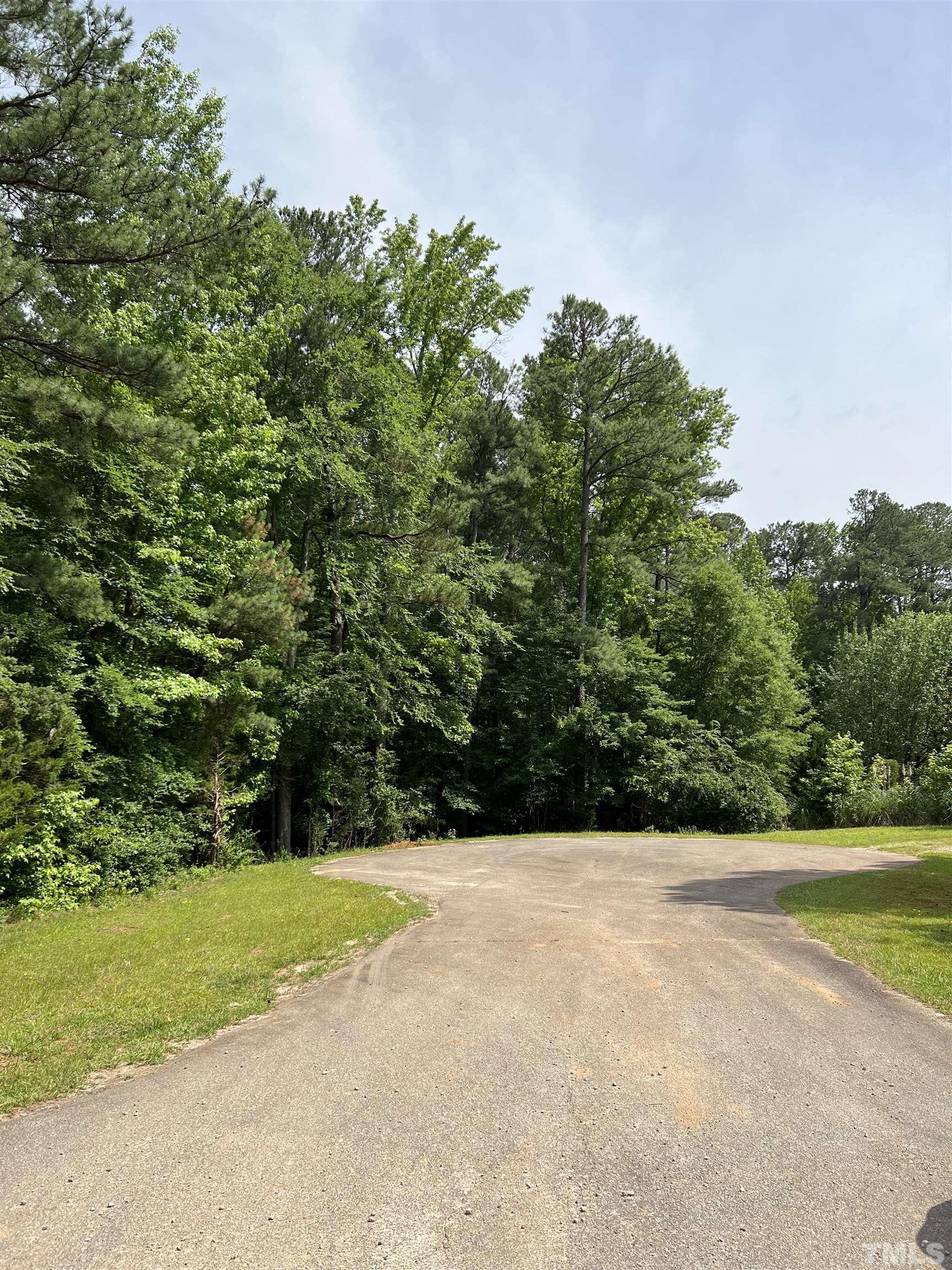 113 Wichita Way Louisburg, NC 27549 - Photo 2 of 5 a view of a yard with a trees