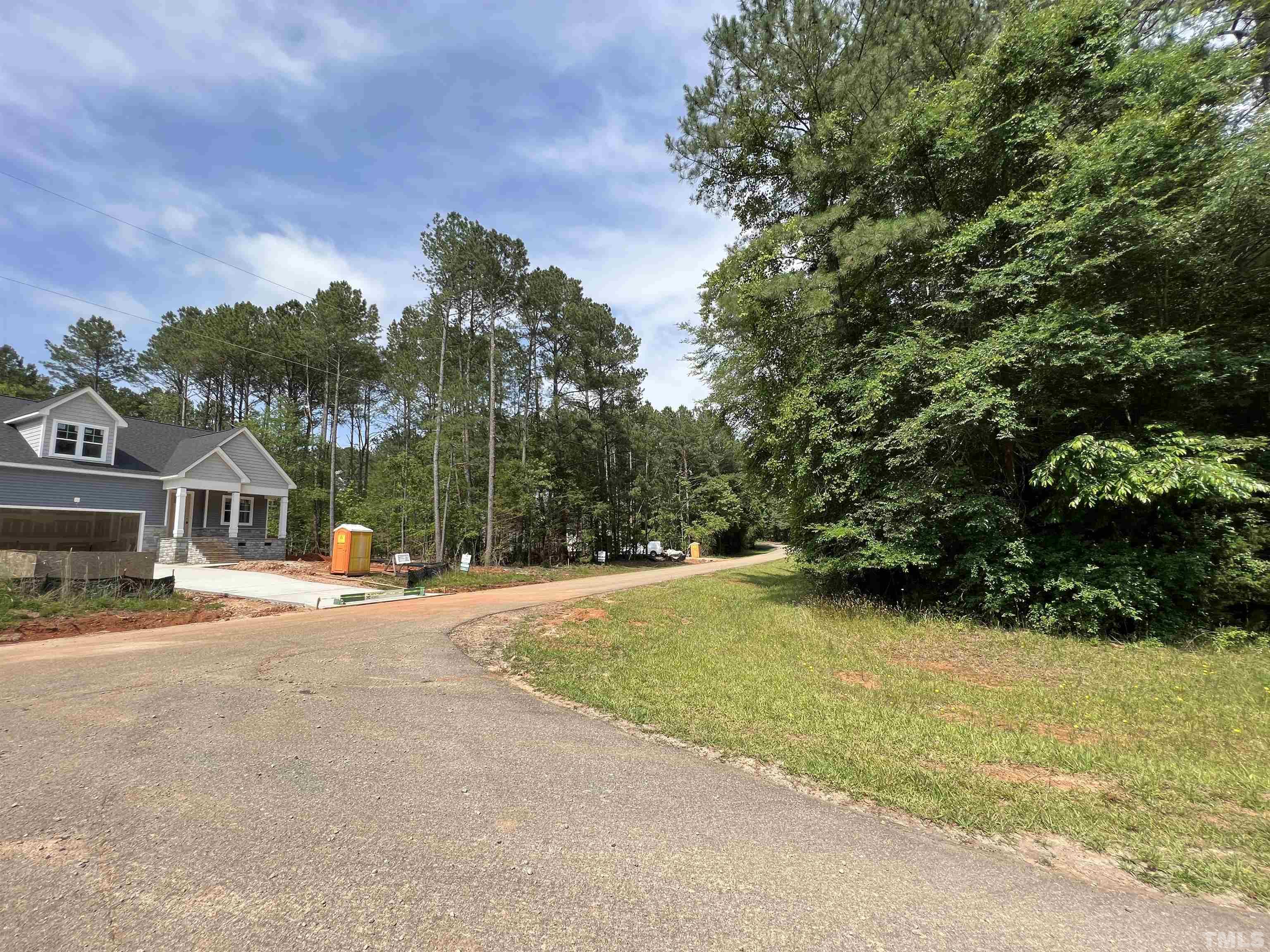 113 Wichita Way Louisburg, NC 27549 - Photo 3 of 5 a view of a house with a yard and basketball court