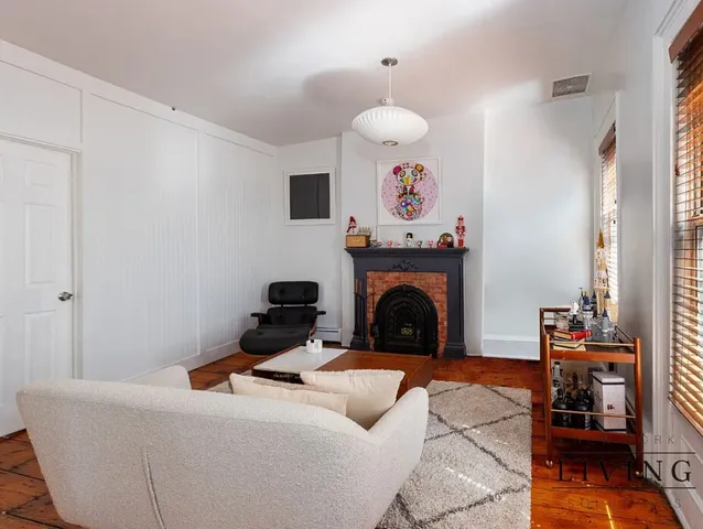 a living room with furniture and a fireplace