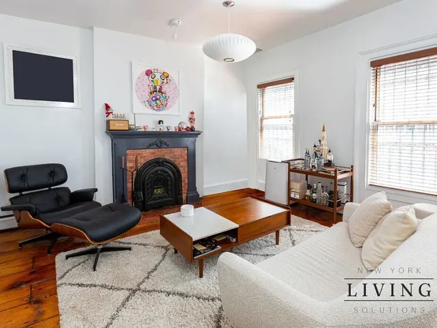 a living room with furniture a rug and a fireplace