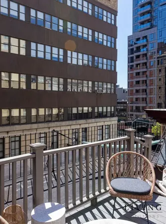 a balcony view with a seating space