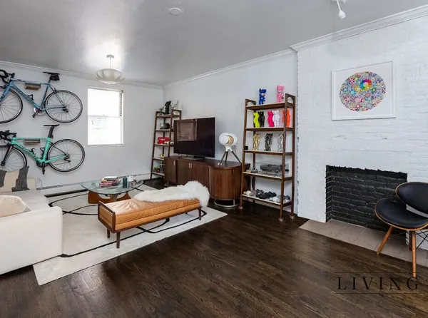 a living room with furniture a flat screen tv and a fireplace
