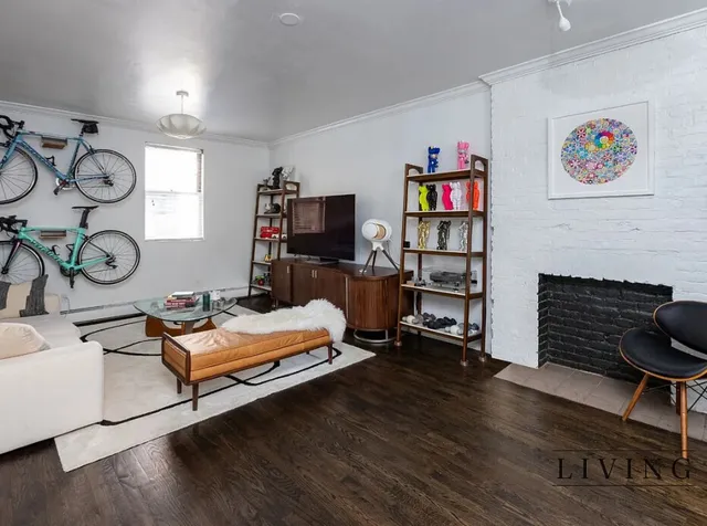 a living room with furniture a flat screen tv and a fireplace