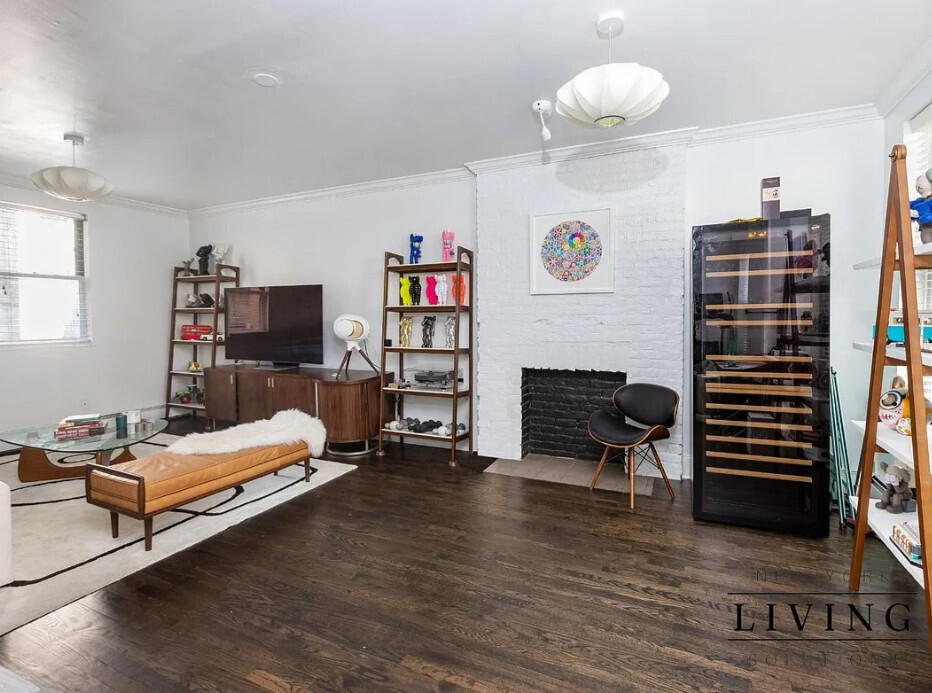 265 West 30th Street Manhattan, NY 10001 - Photo 5 of 20 a bedroom with furniture and a fireplace