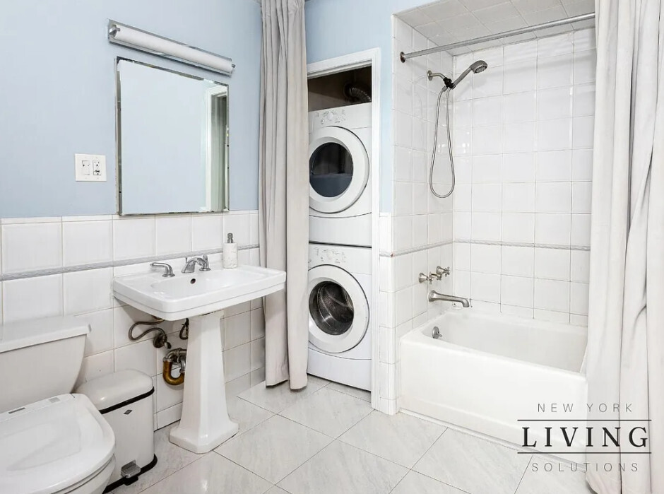 265 West 30th Street Manhattan, NY 10001 - Photo 8 of 20 a bathroom with a sink a toilet and shower