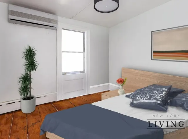 a living room with a couch and potted plant