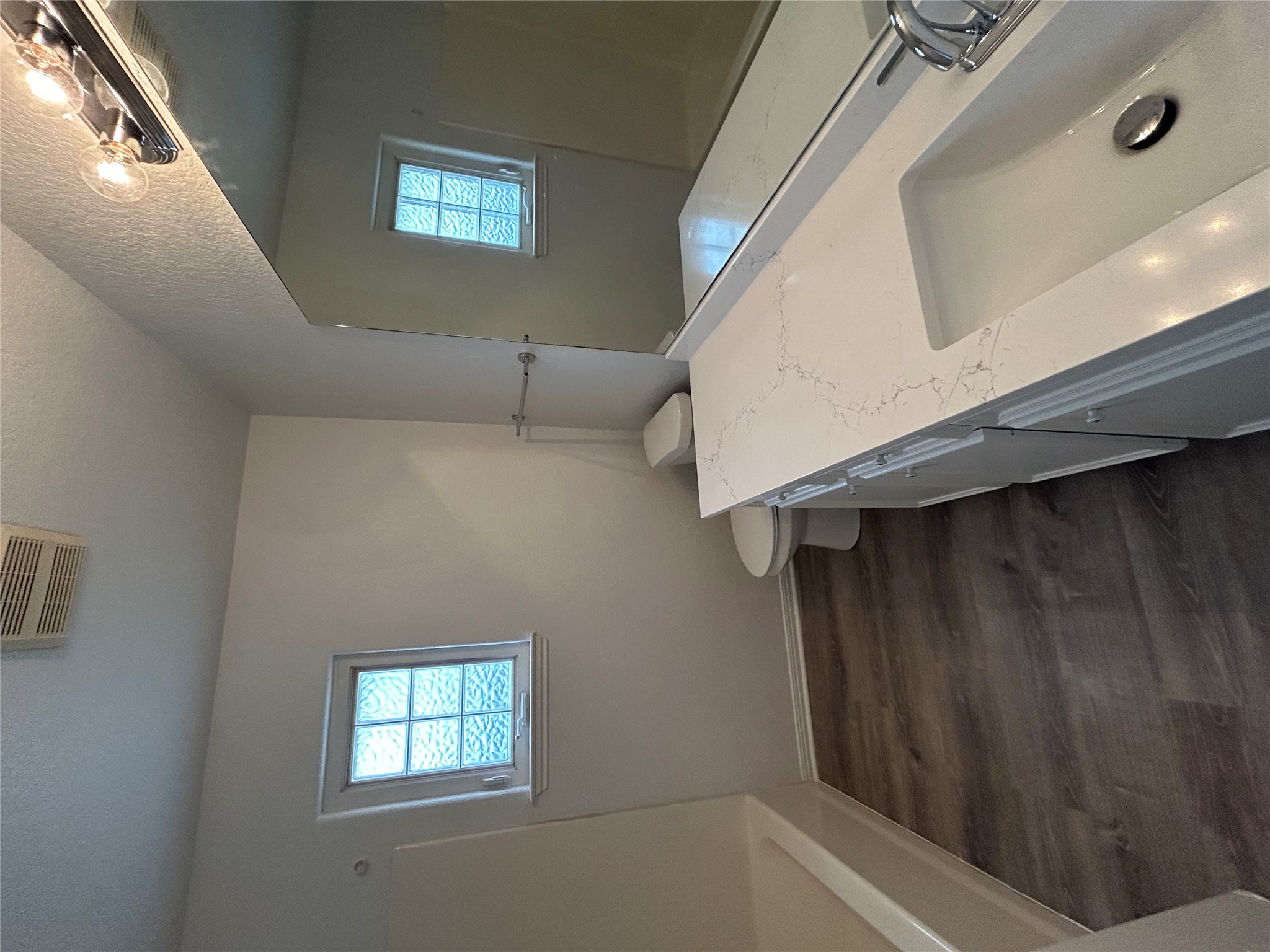 203 Maynard Street Bastrop, TX 78602 - Photo 17 of 27 a bathroom with a sink and a mirror