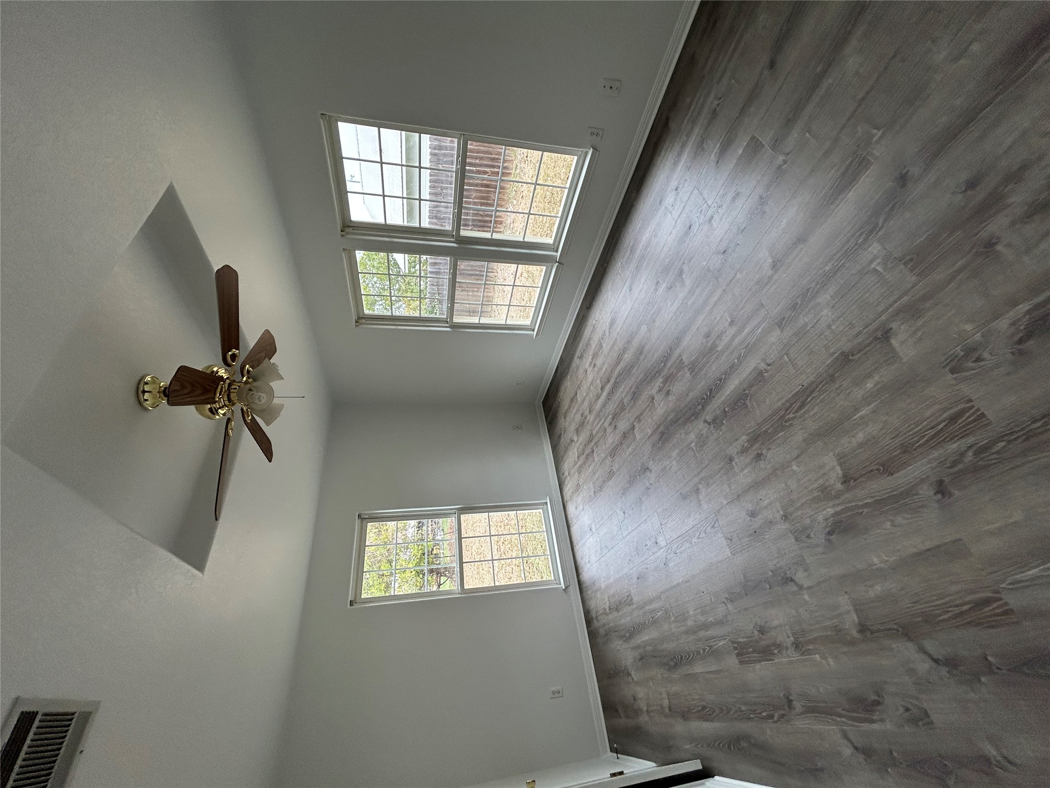 203 Maynard Street Bastrop, TX 78602 - Photo 20 of 27 an empty room with wooden floor chandelier and windows