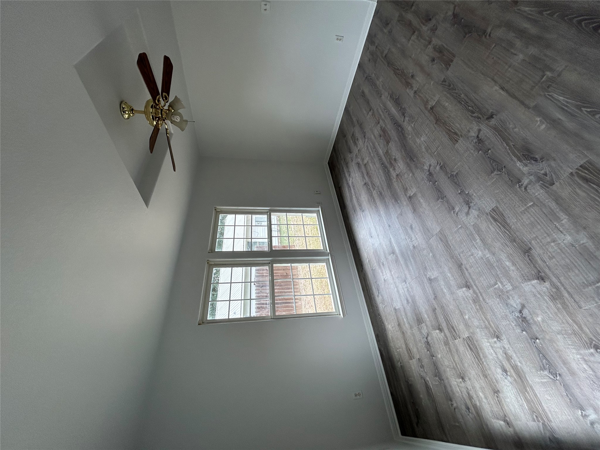 203 Maynard Street Bastrop, TX 78602 - Photo 21 of 27 an empty room with windows and ceiling fan
