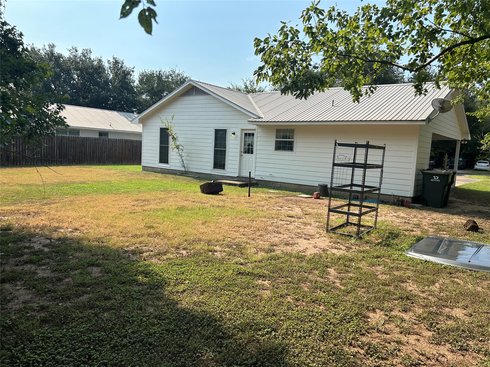 203 Maynard Street Bastrop, TX 78602 - Photo 24 of 27 a backyard of a house with table and chairs