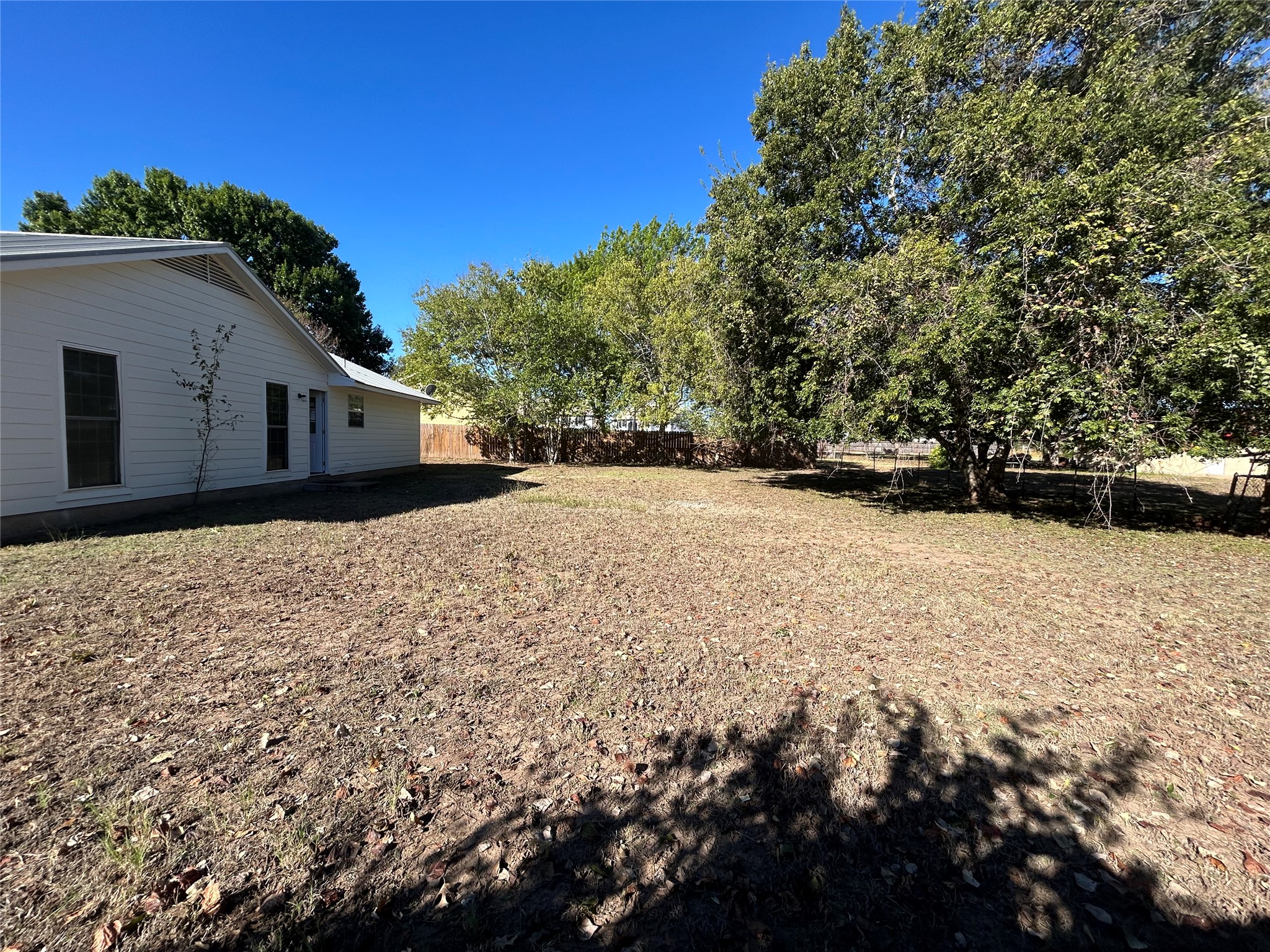 203 Maynard Street Bastrop, TX 78602 - Photo 26 of 27 a view of large house with a yard