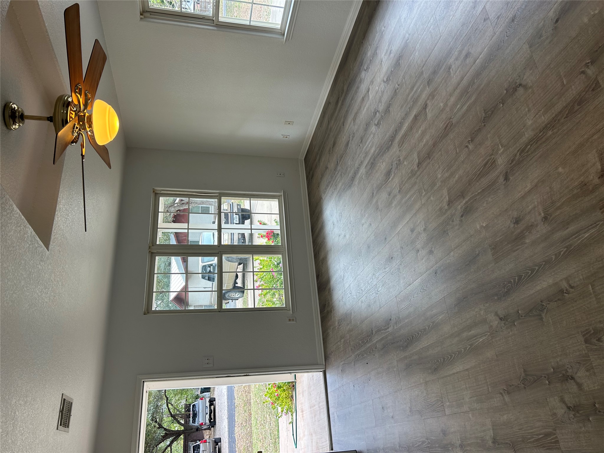 203 Maynard Street Bastrop, TX 78602 - Photo 4 of 27 a view of an empty room with window and wooden floor