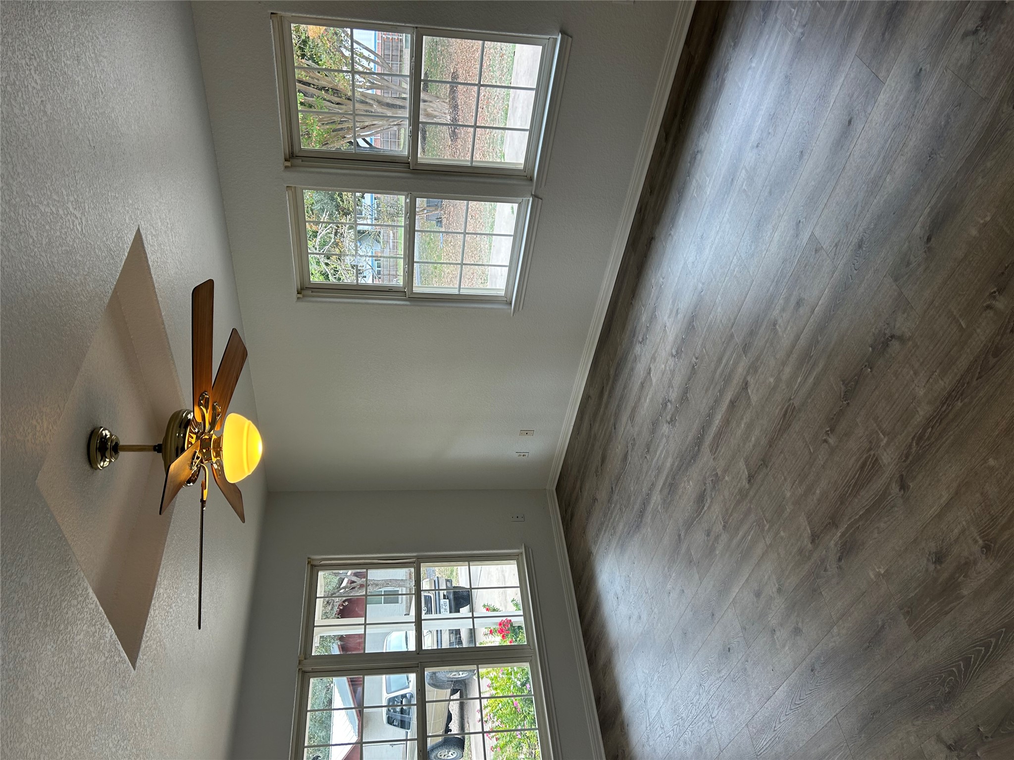 203 Maynard Street Bastrop, TX 78602 - Photo 5 of 27 an empty room with wooden floor and windows