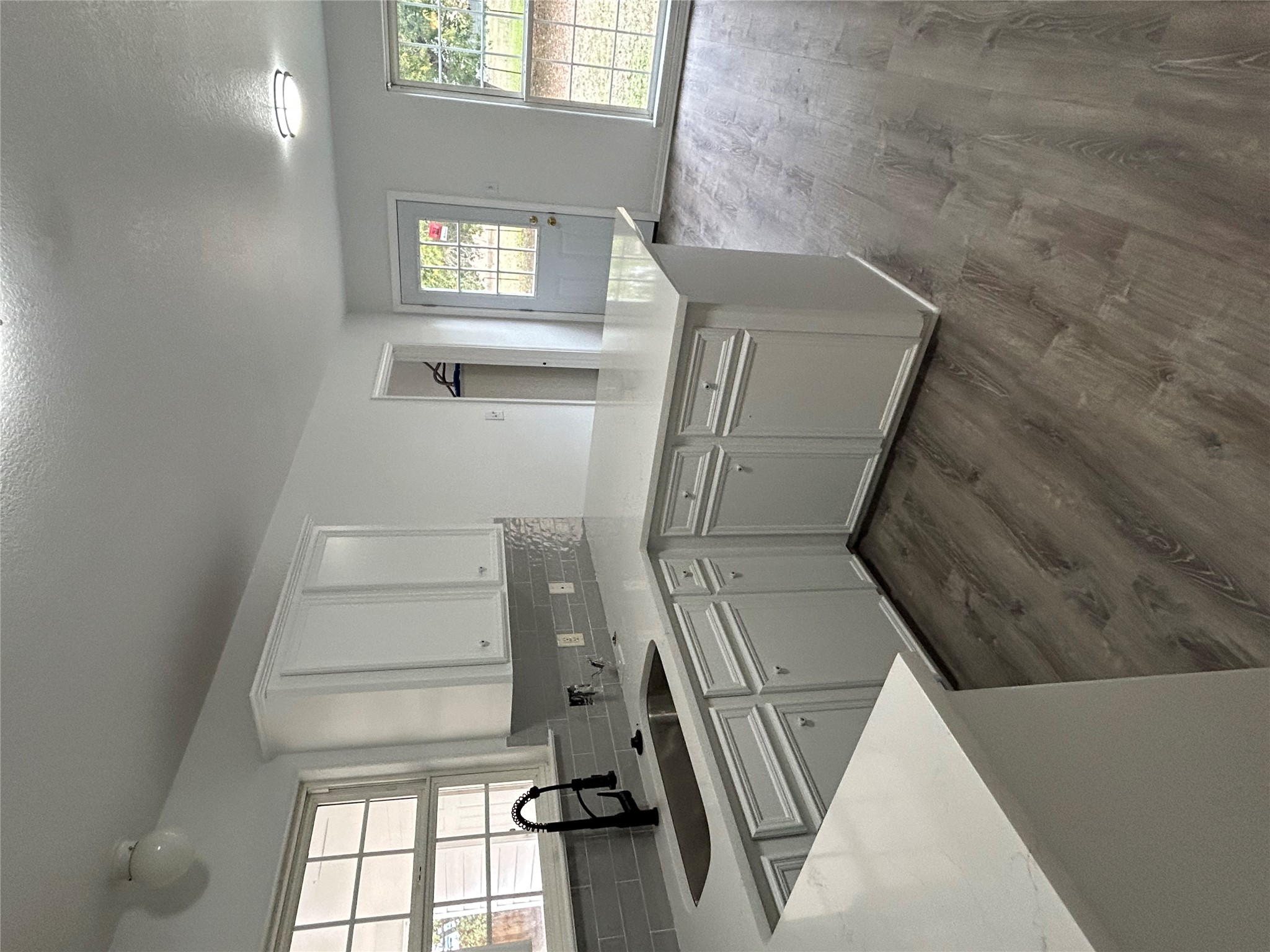 203 Maynard Street Bastrop, TX 78602 - Photo 8 of 27 a kitchen with a sink a window and cabinets