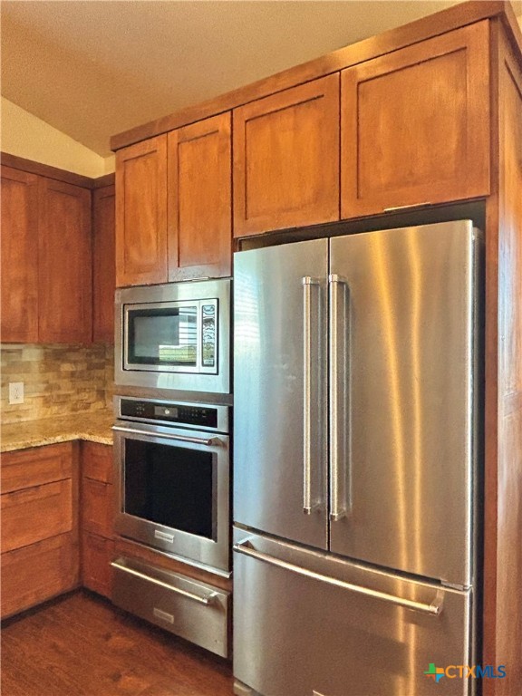 174 Riley Lane Port O'Connor, TX 77982 - Photo 12 of 47 a metallic refrigerator sitting in a kitchen