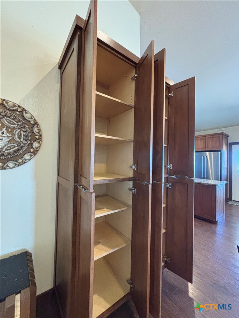 174 Riley Lane Port O'Connor, TX 77982 - Photo 15 of 47 a view of walk in closet with empty racks