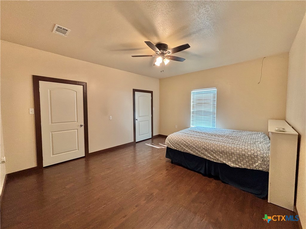 174 Riley Lane Port O'Connor, TX 77982 - Photo 28 of 47 a bedroom with a bed and a ceiling fan