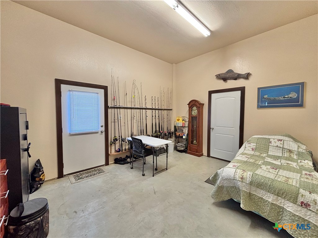 174 Riley Lane Port O'Connor, TX 77982 - Photo 46 of 47 a bedroom with furniture and a flat screen tv