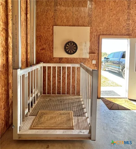 a view of a room with wooden floor and cabinet