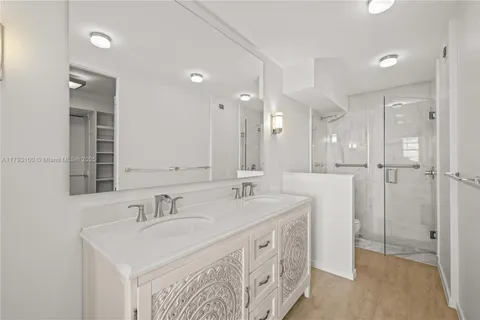 a bathroom with a sink double vanity and a mirror