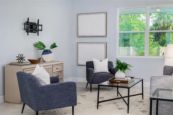 a living room with furniture potted plant and a mirror