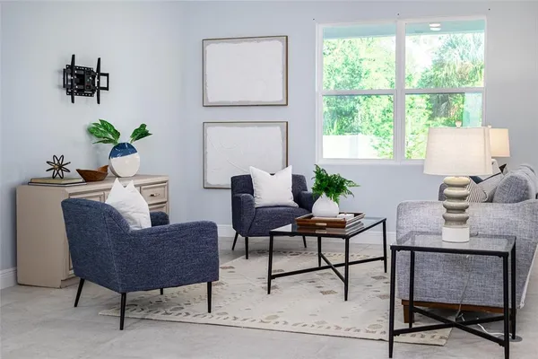 a living room with furniture a flat screen tv and a fireplace