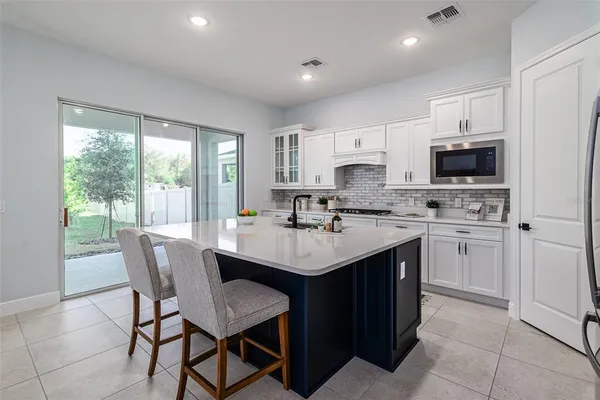 a kitchen with white cabinets and a stove