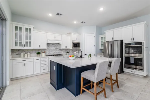 a kitchen with a sink a stove and cabinets