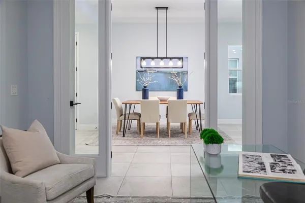 a living room with furniture and a mirror